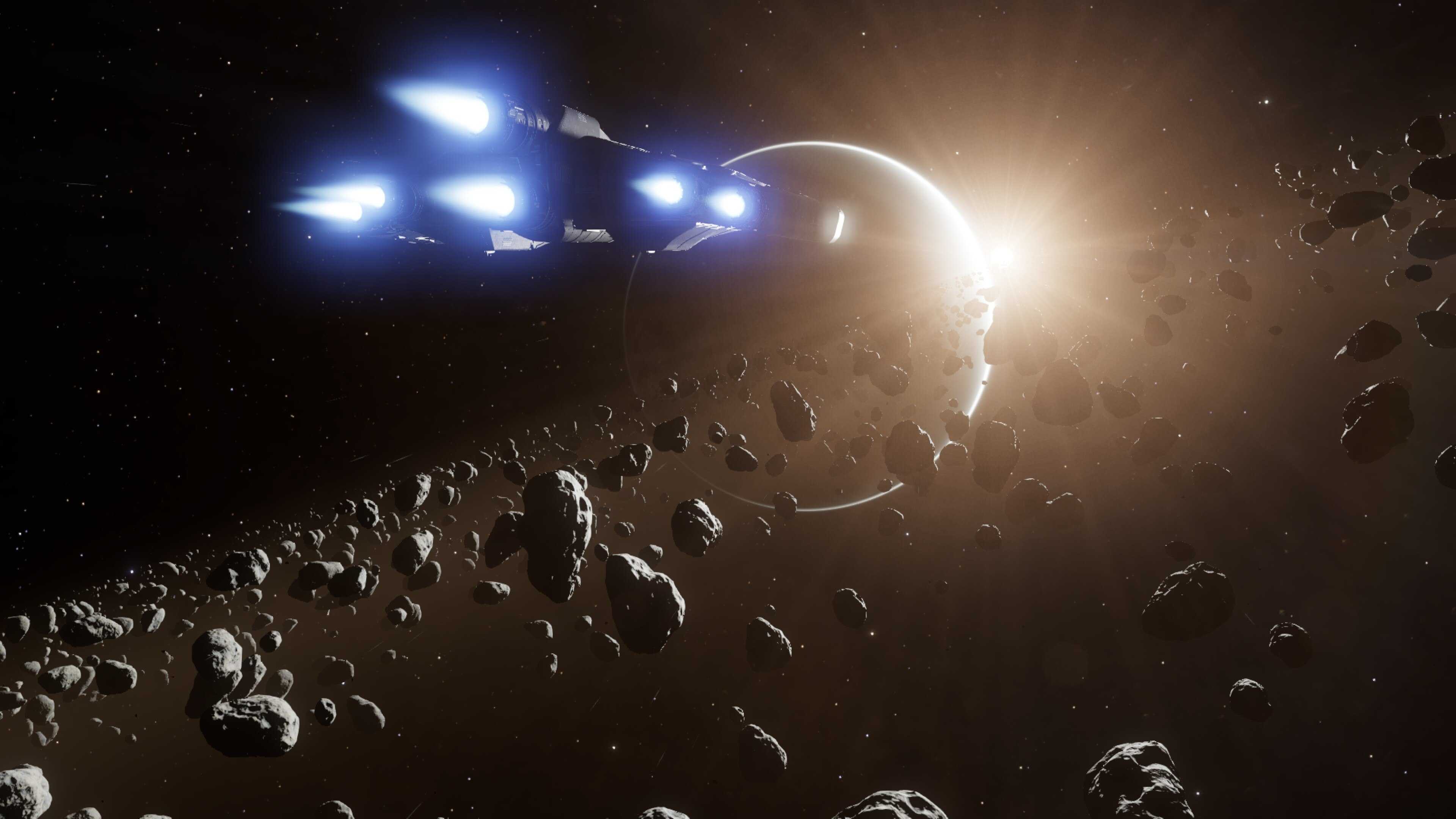 A screenshot from Elite Dangerous, with a ship in a ring system facing the disc of a gas giant, backlit by the planet's sun on the limb of the world.